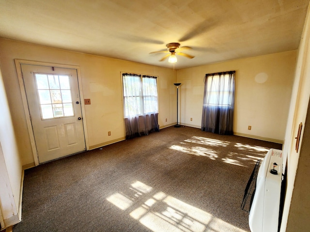 interior space featuring heating unit, carpet, and ceiling fan