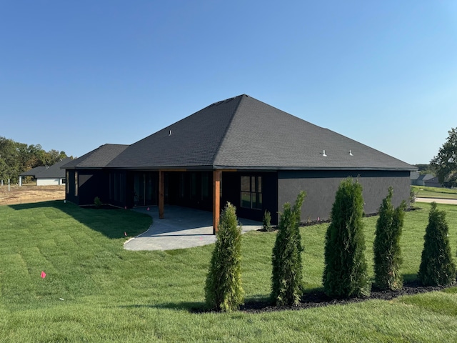 rear view of house with a yard