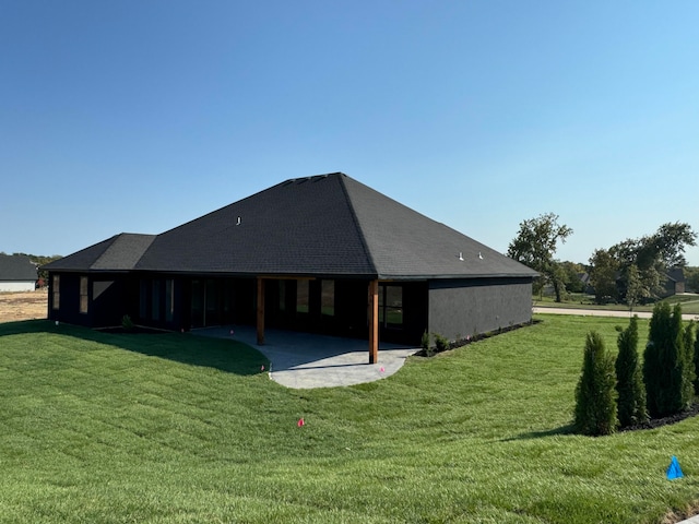 back of house featuring a patio and a lawn