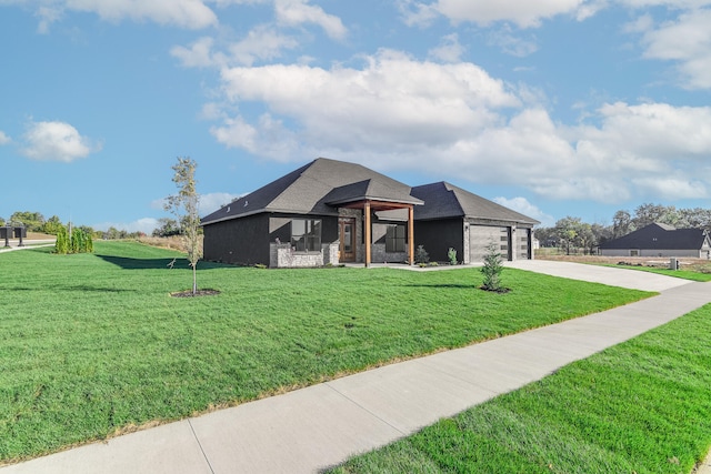 view of front of home featuring a garage and a front yard