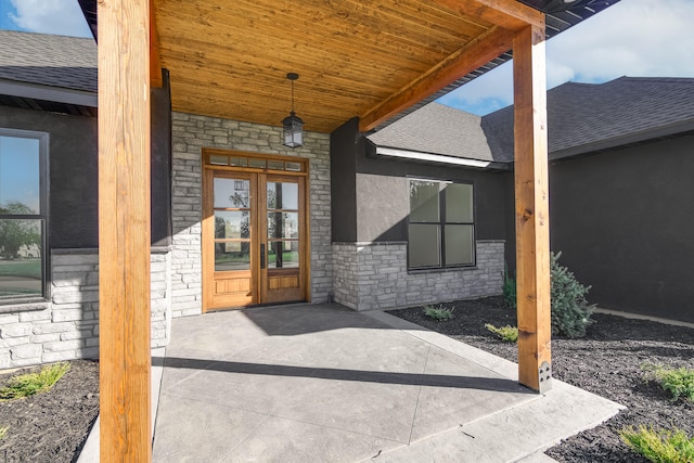 property entrance featuring a patio and french doors