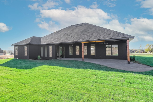 back of house featuring a patio area and a lawn