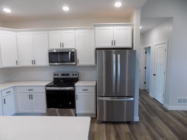 14 Carnival Ln, Centralia, MO 65240 - kitchen with appliances with stainless steel finishes, dark wood-type flooring, light countertops, white cabinetry, and recessed lighting