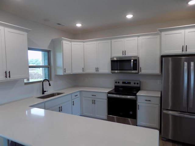 14 Carnival Ln, Centralia, MO 65240 - kitchen featuring appliances with stainless steel finishes, light countertops, white cabinets, and recessed lighting