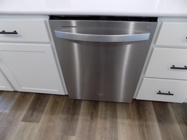 14 Carnival Ln, Centralia, MO 65240 - kitchen view of stainless steel dishwasher, dark wood-style floors, and white cabinetry