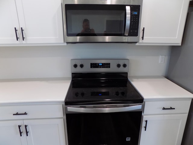 14 Carnival Ln, Centralia, MO 65240 - kitchen with appliances with stainless steel finishes, white cabinets, and light countertops