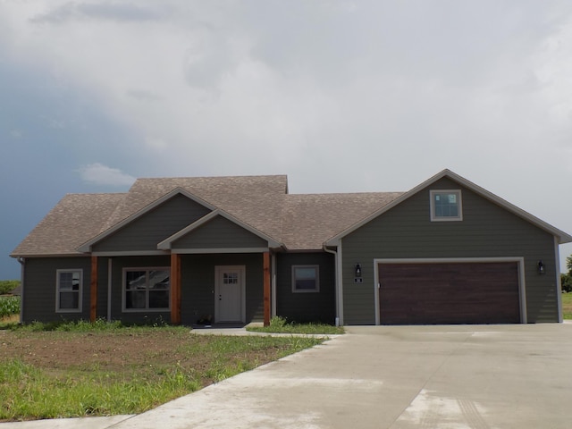 14 Carnival Ln, Centralia, MO 65240 - view of front of home featuring roof with shingles, driveway, and an attached garage