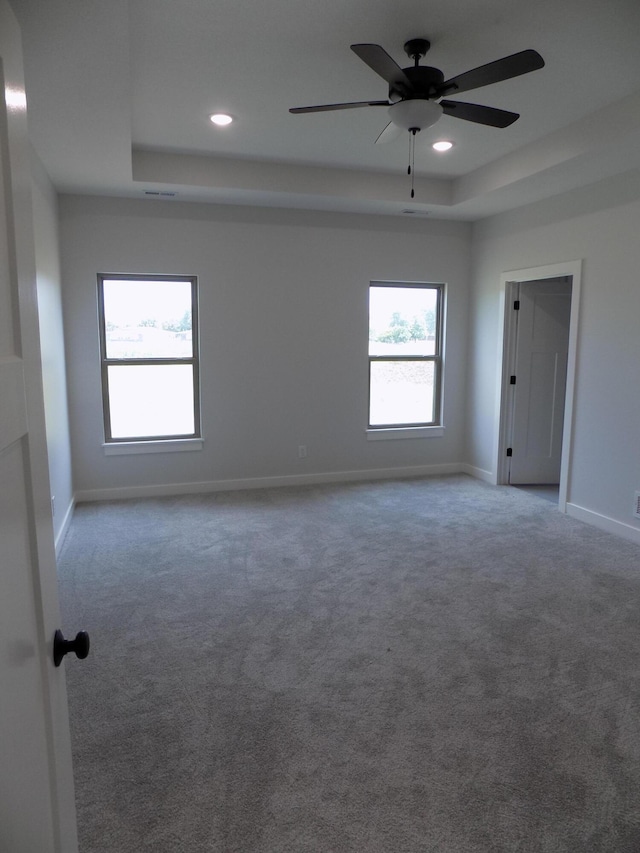 14 Carnival Ln, Centralia, MO 65240 - carpeted empty room with a raised ceiling, recessed lighting, and a ceiling fan