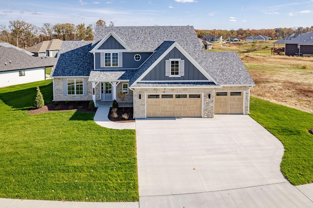 craftsman-style home featuring a front lawn and a garage