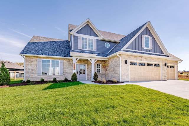 craftsman house with a front yard and a garage