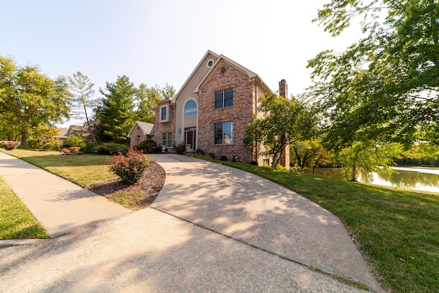 front of property featuring a front yard and a water view