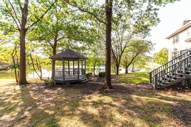 view of yard with a gazebo and a water view