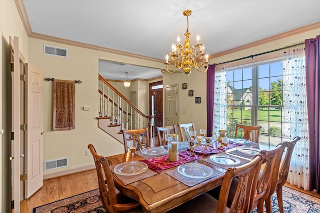 dining area featuring an inviting chandelier, light hardwood / wood-style flooring, and ornamental molding