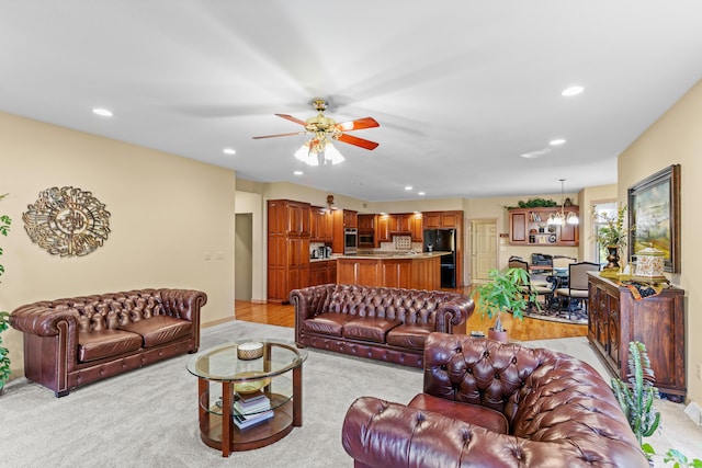 carpeted living room with ceiling fan