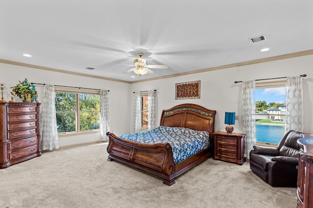 carpeted bedroom with ceiling fan and crown molding