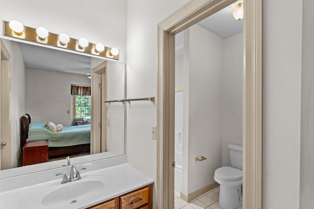 bathroom featuring vanity, toilet, and tile patterned flooring