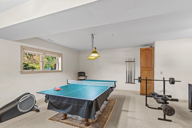 rec room featuring a textured ceiling and light colored carpet