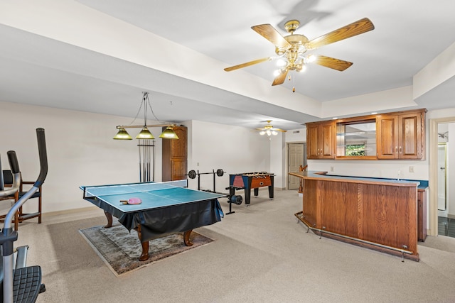 game room with ceiling fan, bar area, and light colored carpet