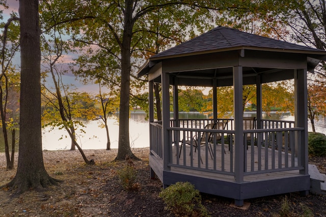 view of community with a deck with water view and a gazebo