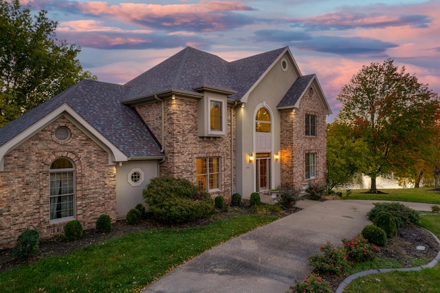 french provincial home featuring a lawn