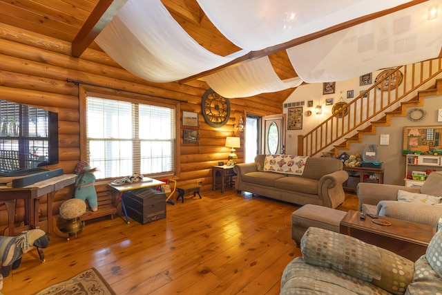 living room featuring rustic walls, hardwood / wood-style floors, and vaulted ceiling with beams