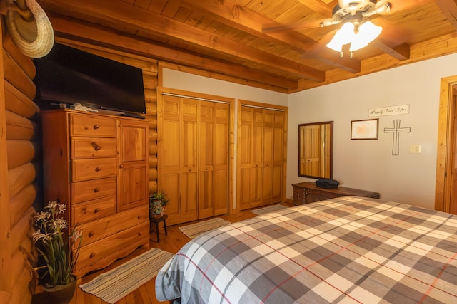 bedroom with wood ceiling, hardwood / wood-style floors, beam ceiling, and ceiling fan