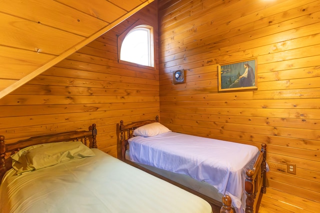 bedroom featuring wood walls