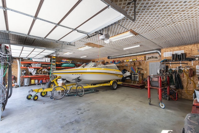 garage featuring a garage door opener and a workshop area