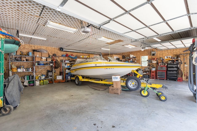 garage with a garage door opener and a workshop area