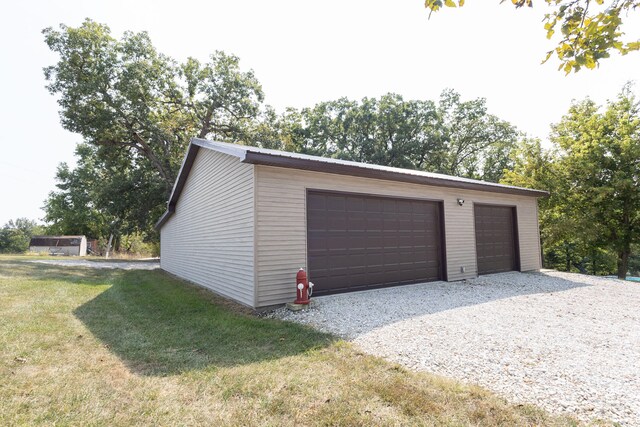 garage featuring a lawn