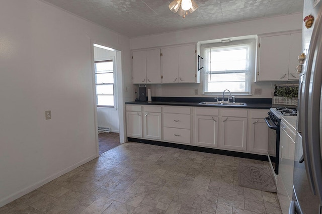 kitchen with white cabinets, sink, and a healthy amount of sunlight