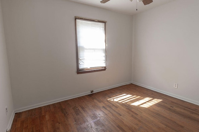 empty room with dark hardwood / wood-style flooring and ceiling fan