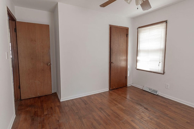 unfurnished bedroom with ceiling fan and dark hardwood / wood-style floors