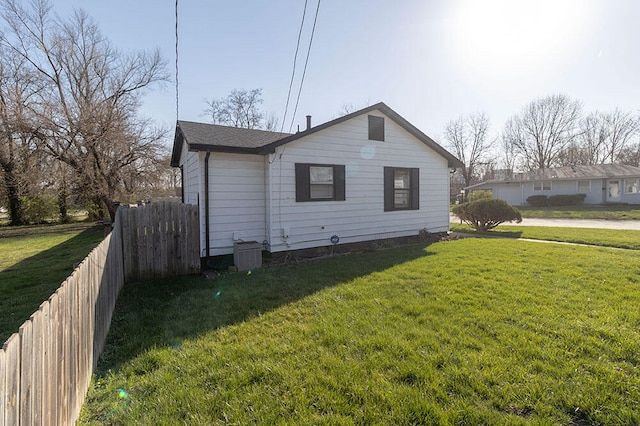 view of side of home with a yard