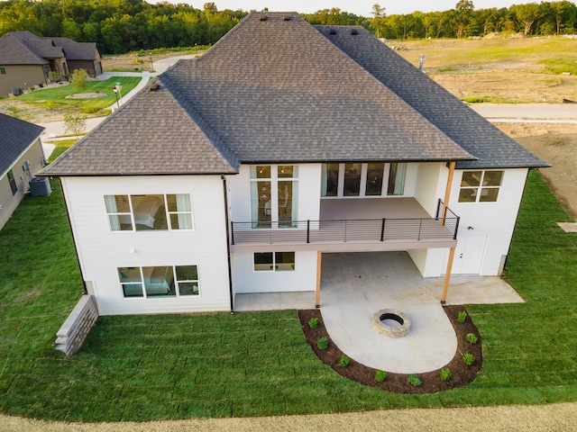 back of property with a lawn and a patio area