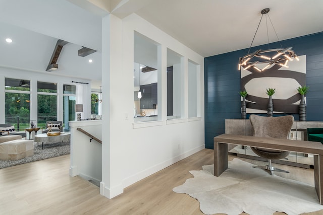 dining space with light wood-type flooring, a chandelier, beamed ceiling, and wooden walls