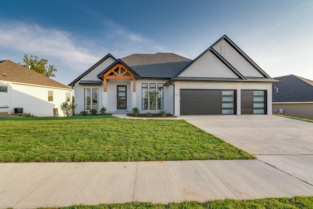 view of front of home featuring a front yard and a garage