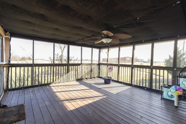 unfurnished sunroom featuring ceiling fan