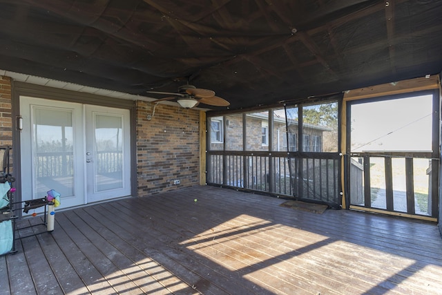 unfurnished sunroom with ceiling fan and french doors