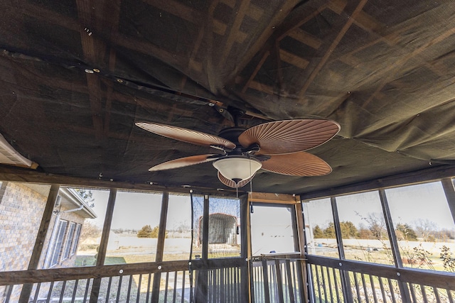 unfurnished sunroom with ceiling fan