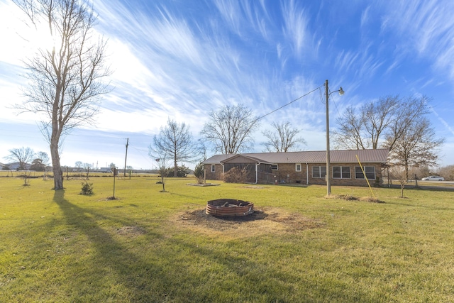 view of yard featuring an outdoor fire pit