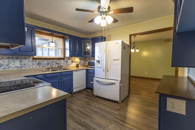 kitchen featuring white appliances, decorative light fixtures, blue cabinets, and sink