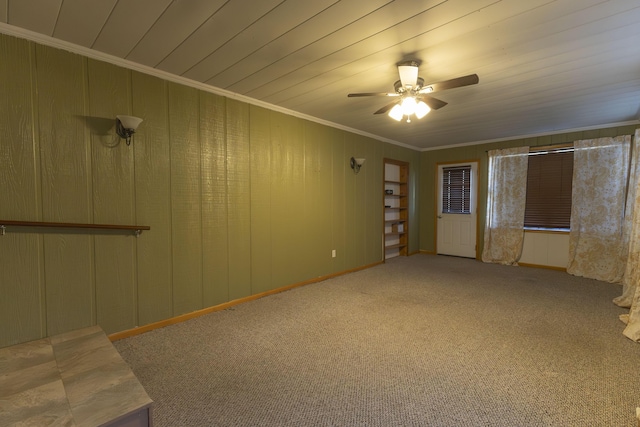 carpeted spare room featuring ceiling fan, wood ceiling, and ornamental molding