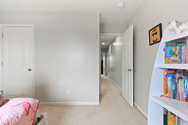 bedroom featuring baseboards and light carpet