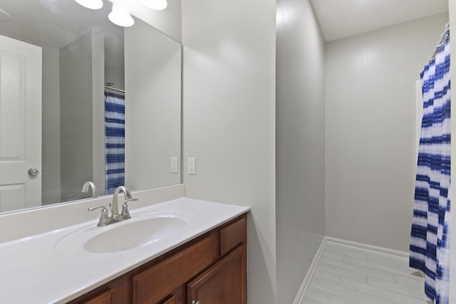 bathroom featuring baseboards and vanity