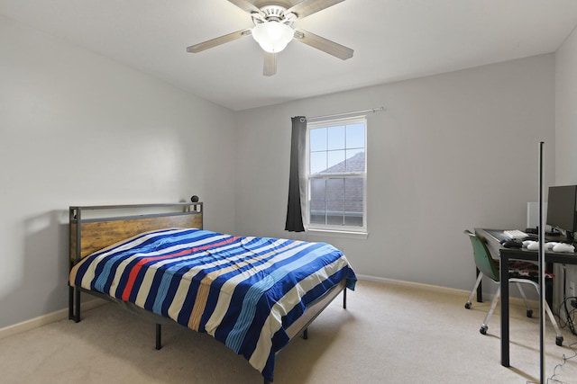 carpeted bedroom featuring baseboards and a ceiling fan