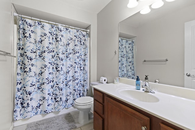 bathroom with vanity, toilet, and tile patterned floors