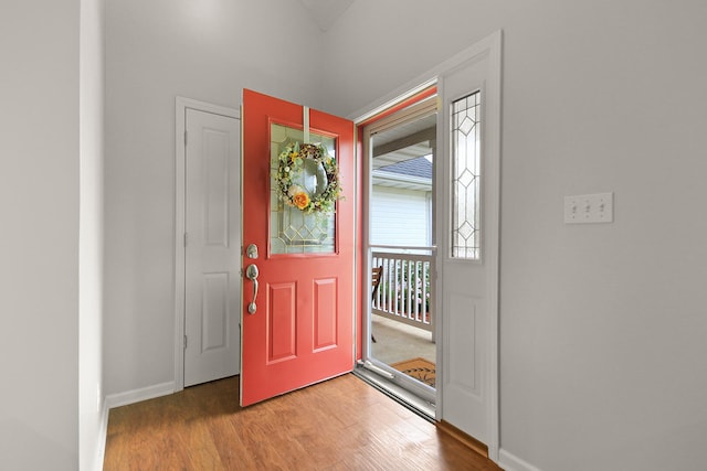 foyer entrance featuring light wood finished floors and baseboards