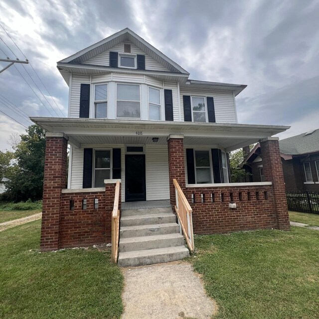 view of front of property with a porch and a front lawn