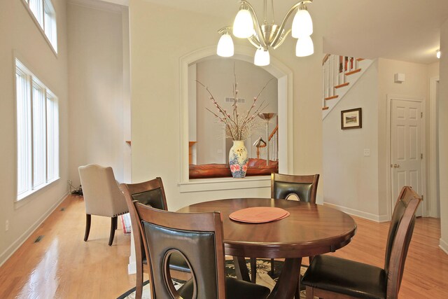 dining space featuring an inviting chandelier and light hardwood / wood-style floors